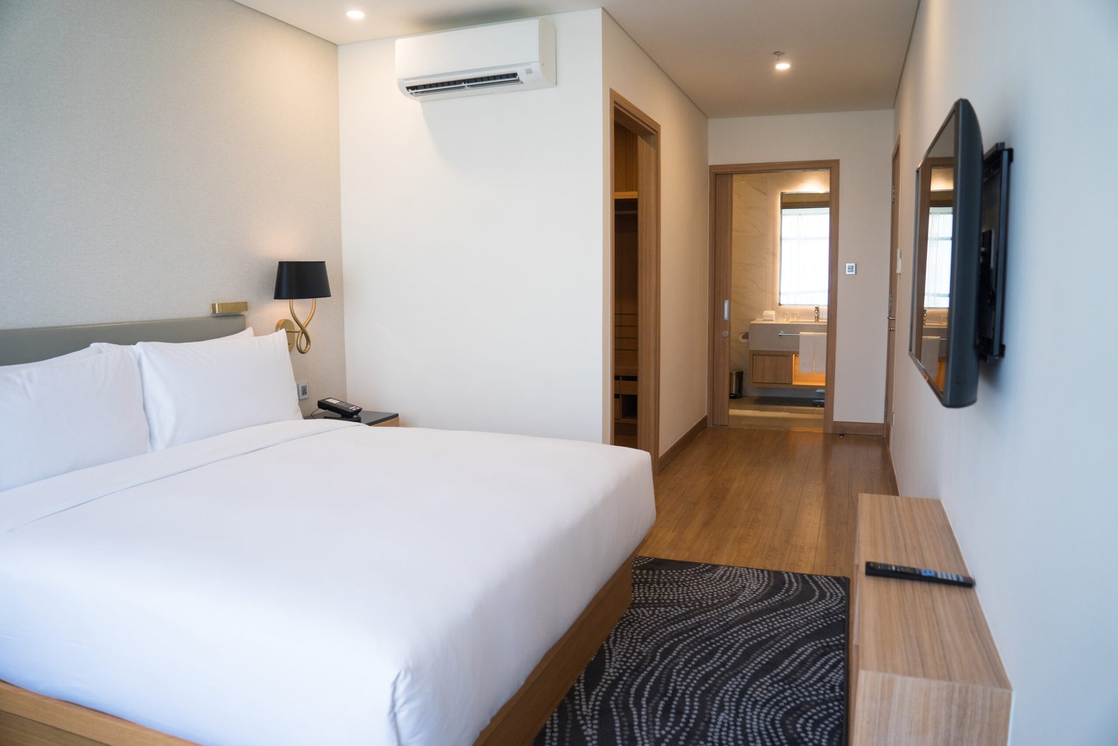 Hoteles small hotel room interior with double bed and bathroom